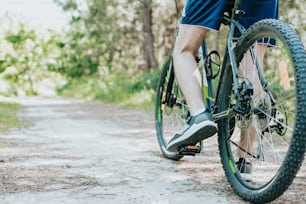 a man riding a bike down a dirt road