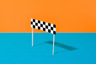 a black and white checkered flag on a blue and orange background