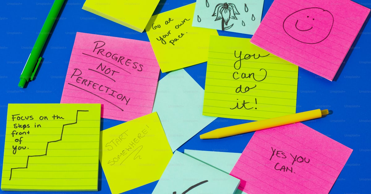 A pile of post it notes sitting on top of a blue table photo ...