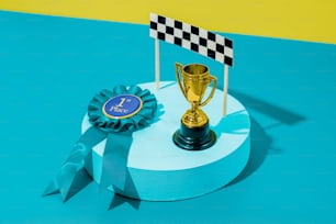 a trophy sitting on top of a table next to a blue ribbon
