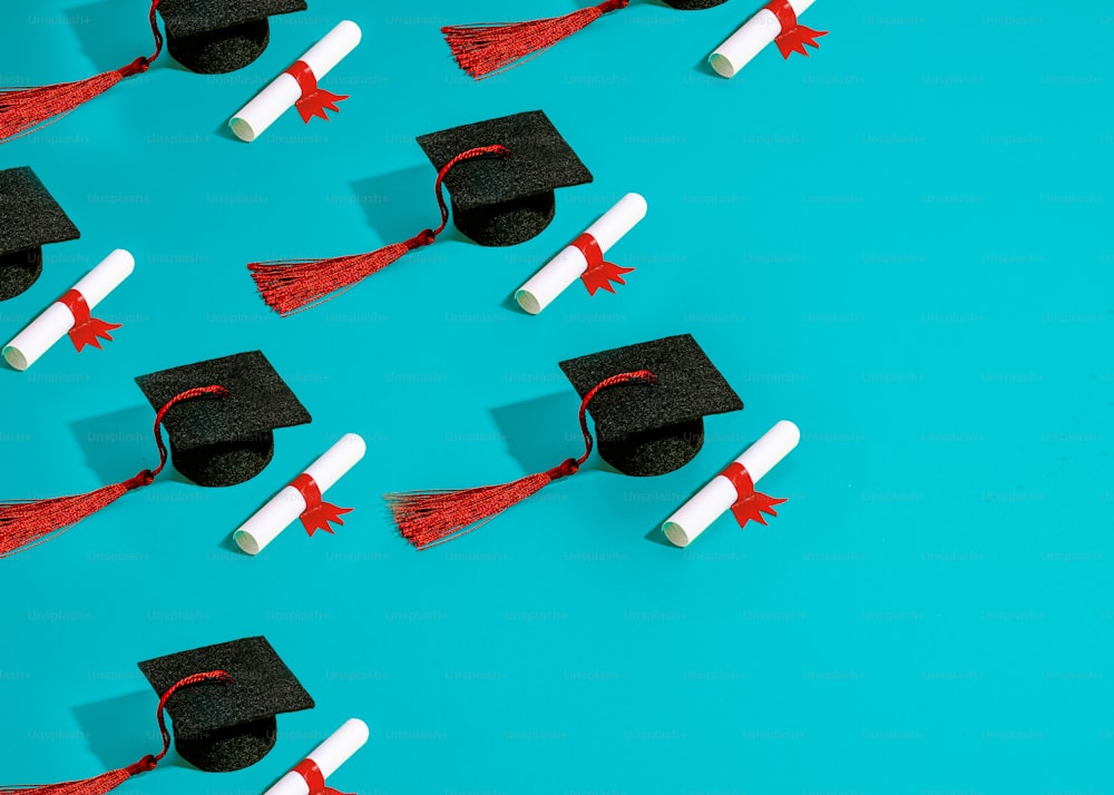a group of graduation caps and tassels on a blue background