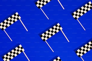 a group of checkered flags flying in the air