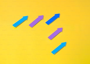 a group of blue and purple arrows on a yellow background