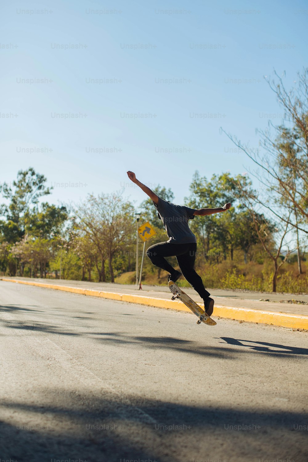 a man riding a skateboard down the side of a road