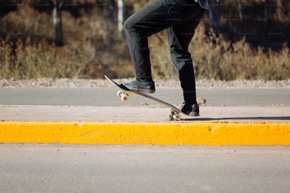 a man riding a skateboard down the side of a road