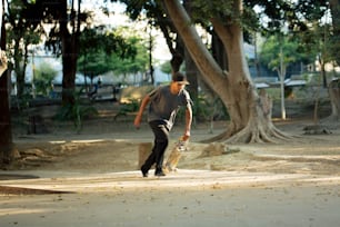 a man holding a skateboard in a park