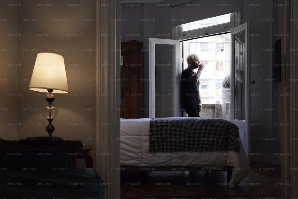 a man standing in the doorway of a bedroom