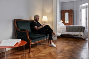 a man sitting in a chair reading a book