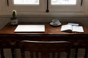 ein Schreibtisch mit einer Tasse Kaffee und einem Notizbuch darauf