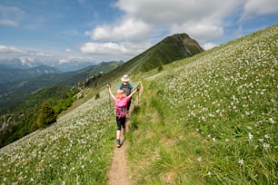 a woman with a child walking up a hill