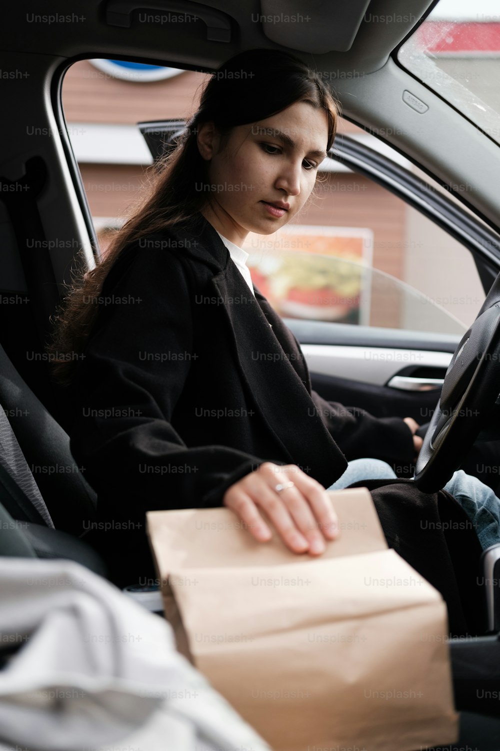 a woman sitting in the back seat of a car