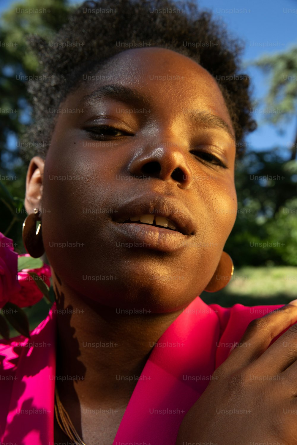 a close up of a person with a flower in her hand