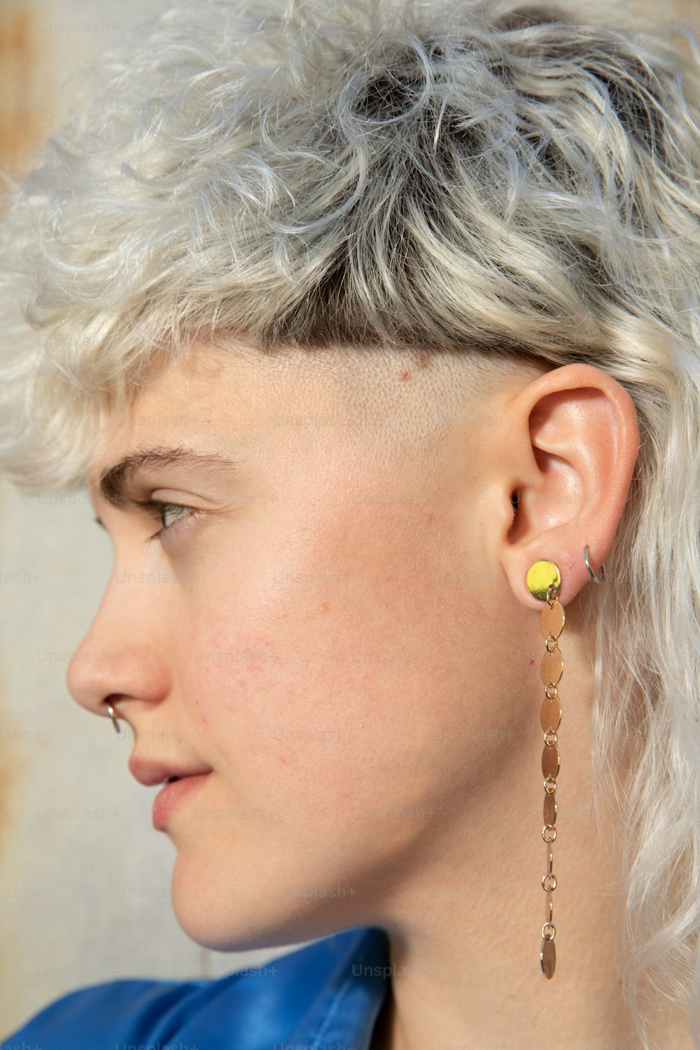 a close up of a person wearing a pair of earrings