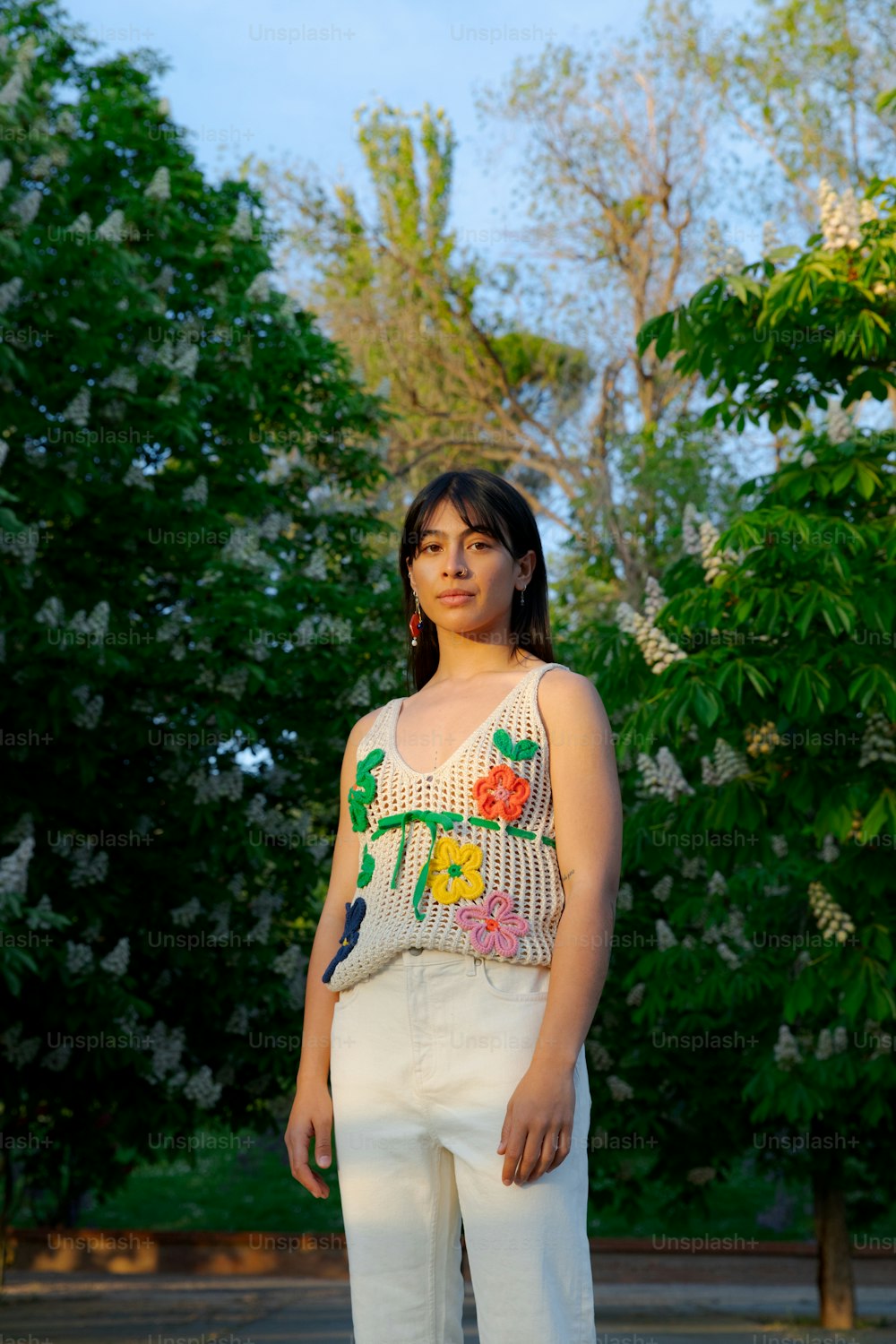 a woman standing in front of a tree