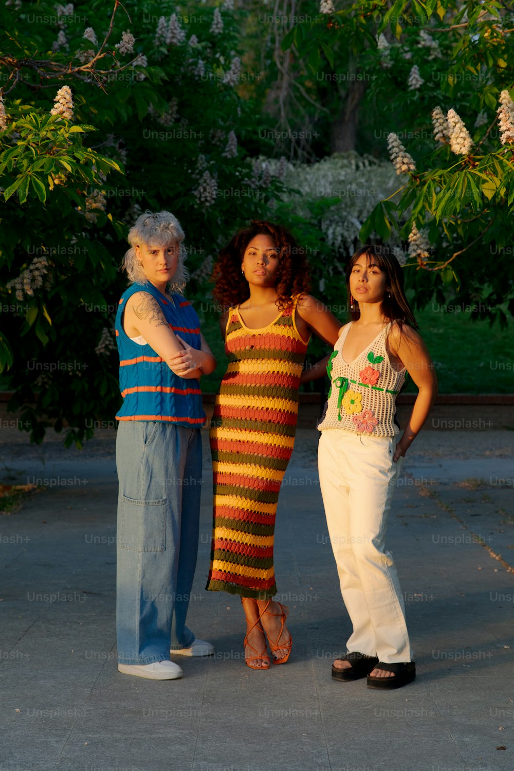 a group of three women standing next to each other