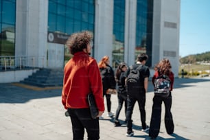 a group of people standing in front of a building