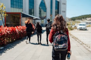 a group of people walking down a sidewalk