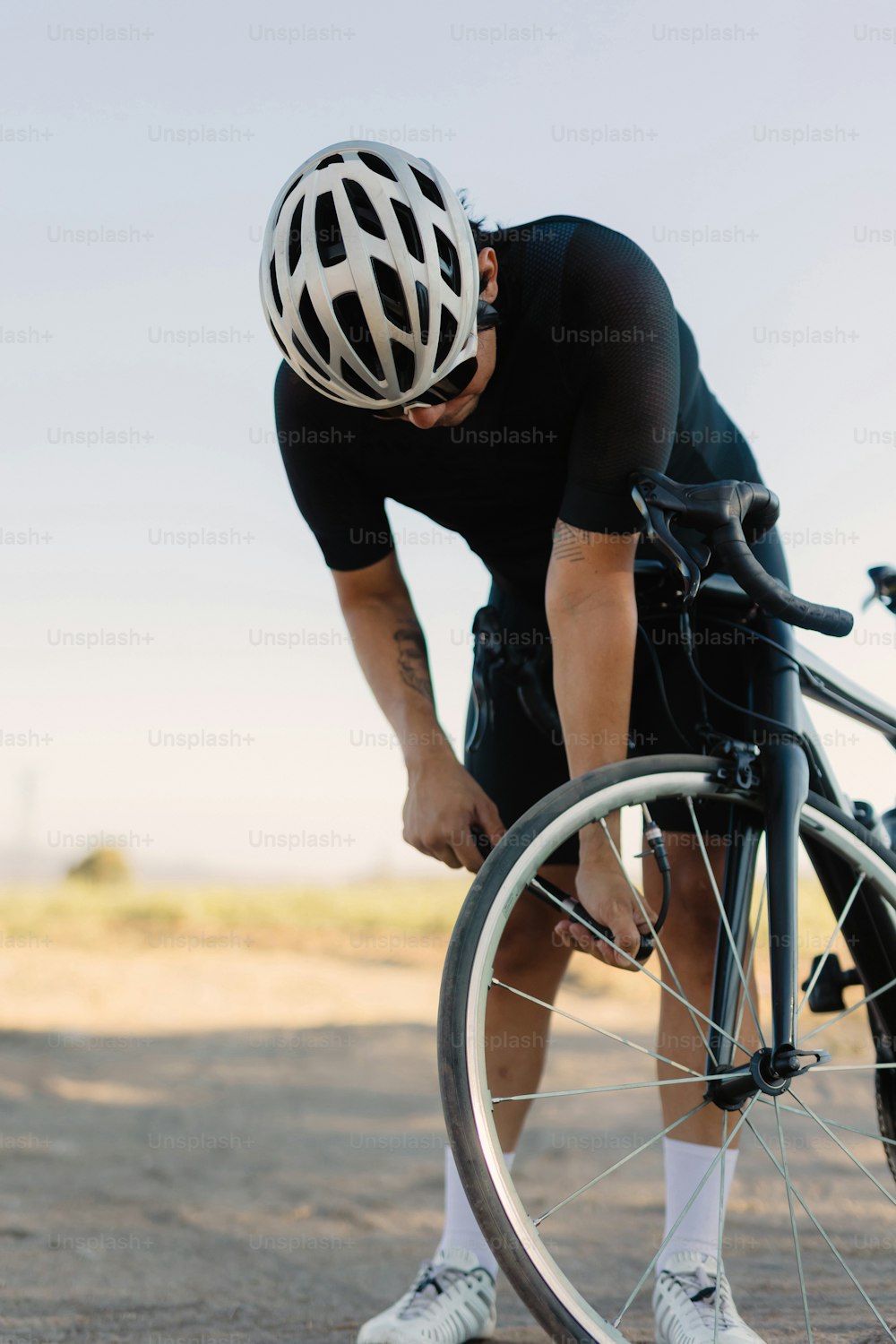 a man in a black shirt and white socks with a bike