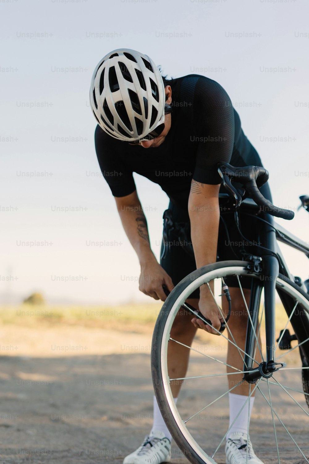 a man in a black shirt and white socks with a bike