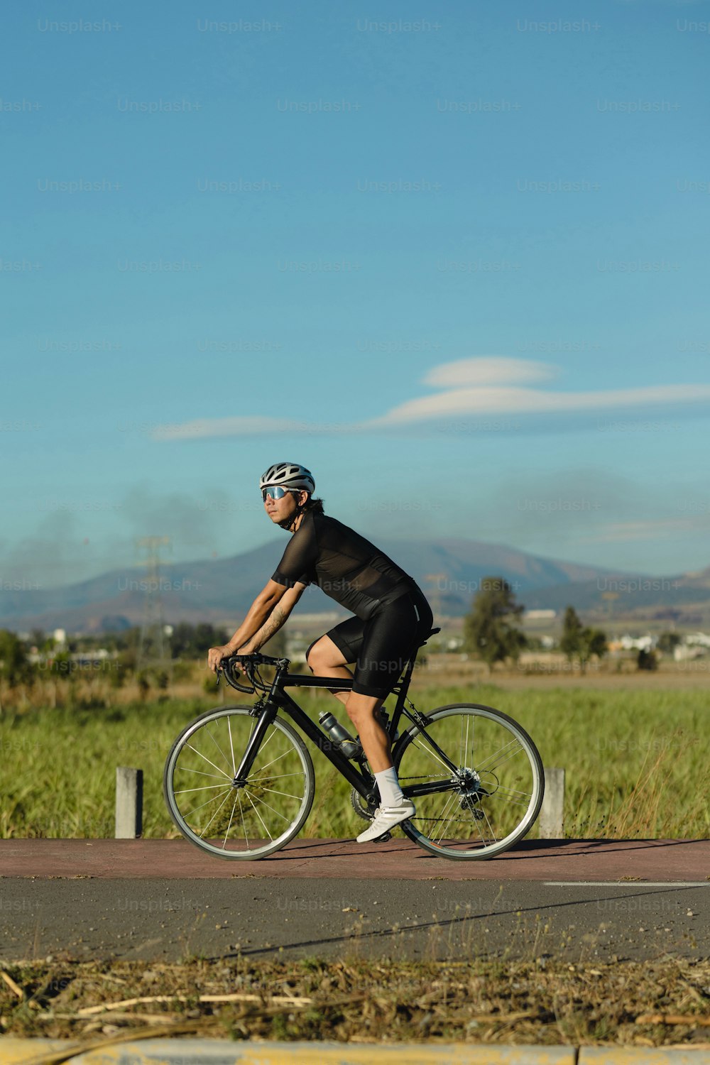 a man riding a bike down a road