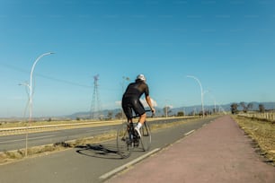 a man riding a bike down a road