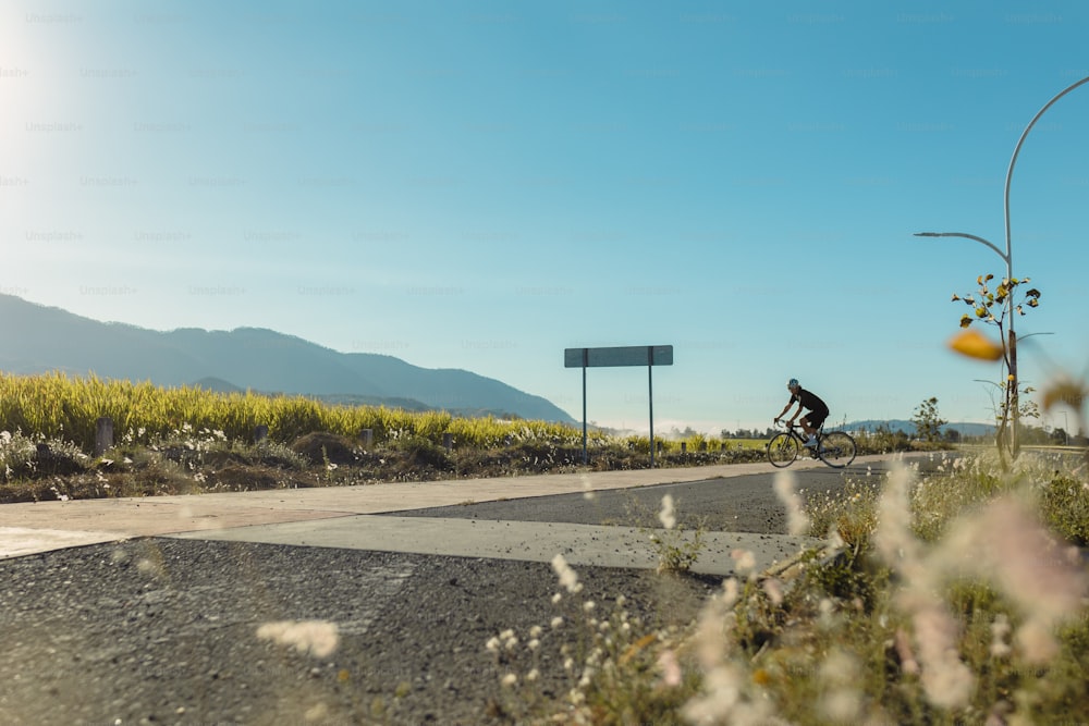 a person riding a bike on a paved road