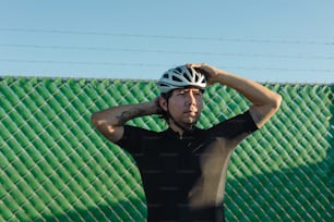 a man in a black shirt and a bike helmet