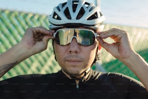 a man wearing a helmet and goggles with his hands on his head