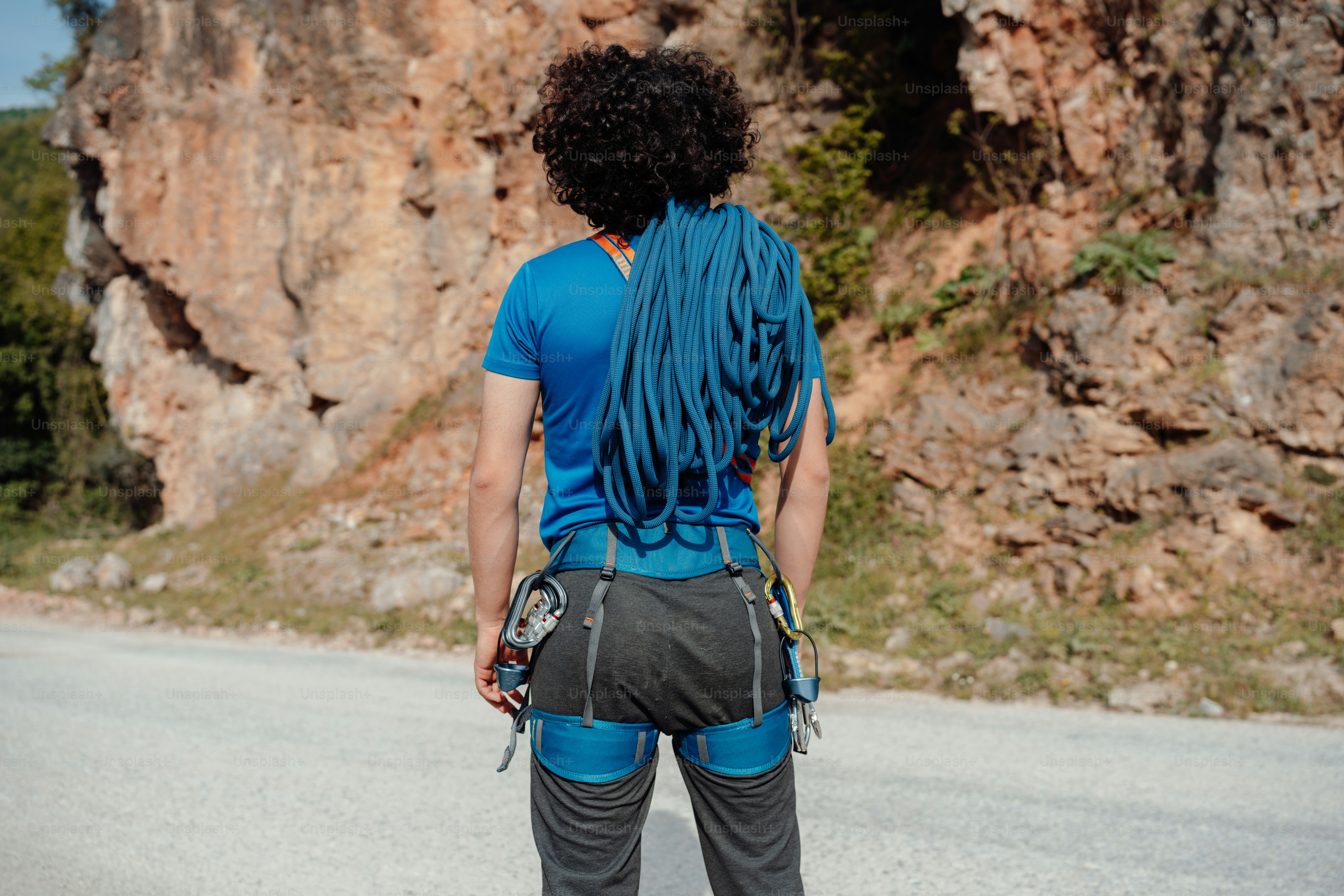 a woman standing on the side of a road