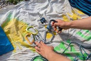 a person holding a pair of scissors on top of a tarp