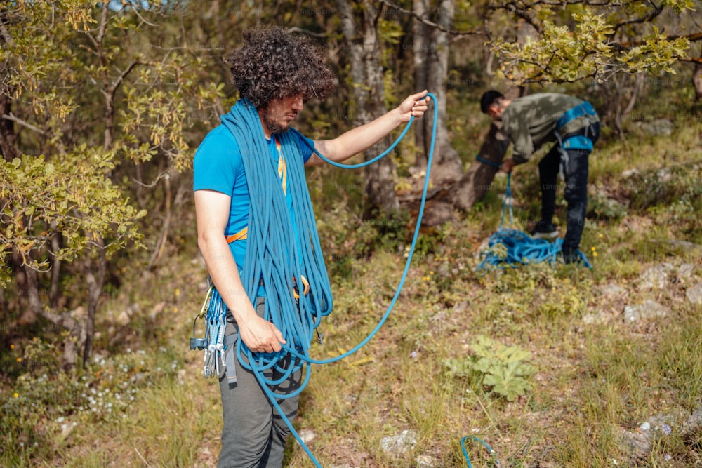 a man with a rope attached to his back in the woods