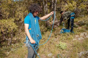 a man with a rope attached to his back in the woods
