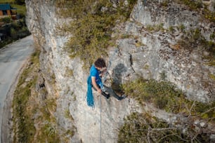 a man climbing up the side of a mountain