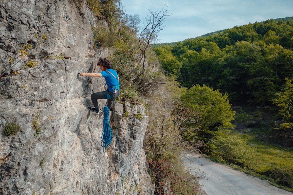 a man climbing up the side of a cliff