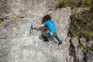 a man climbing up the side of a mountain