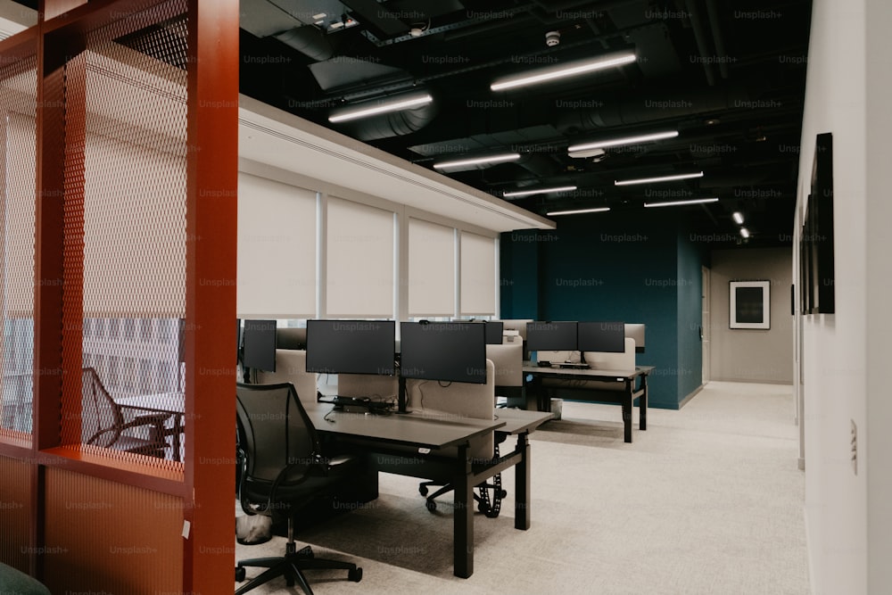 an empty office with desks and chairs