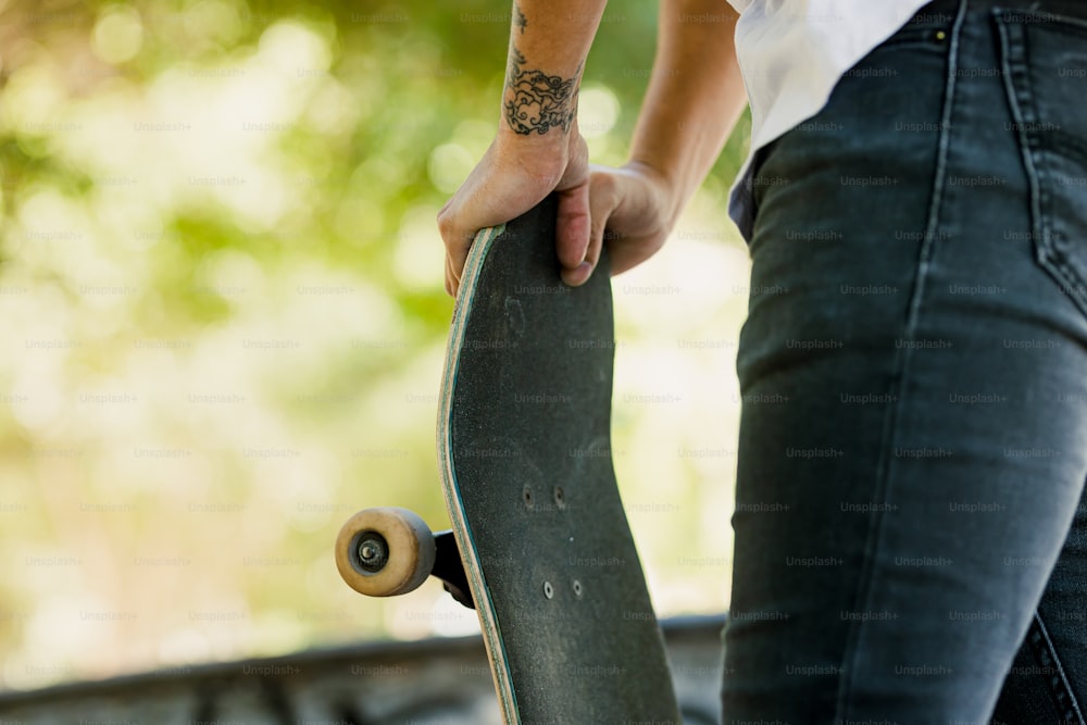 a person holding a skateboard in their hand