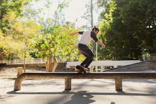 a man riding a skateboard on top of a wooden rail