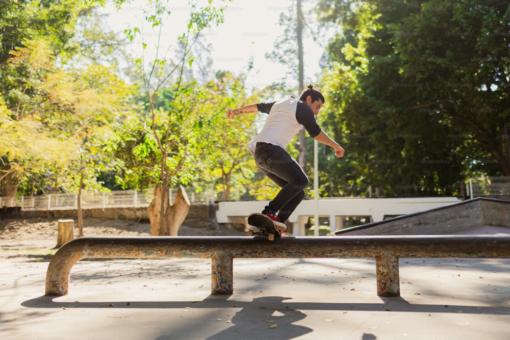 a man riding a skateboard on top of a wooden rail