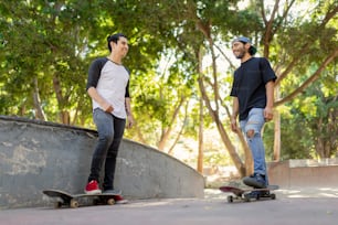 a man standing next to another man on a skateboard