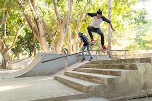 a man riding a skateboard down the side of a set of stairs