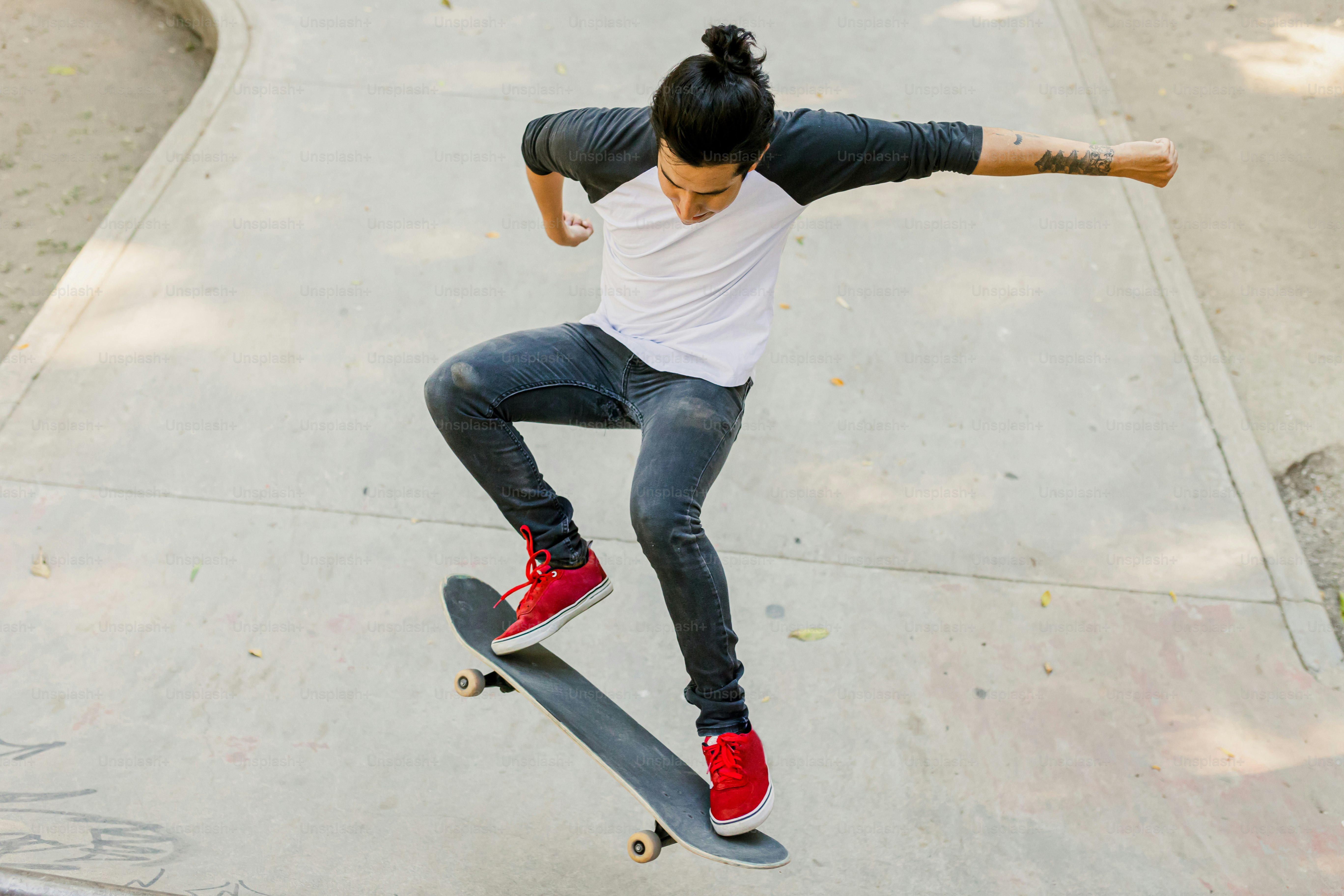 A man riding a skateboard down the side of a ramp photo – Sport Image ...
