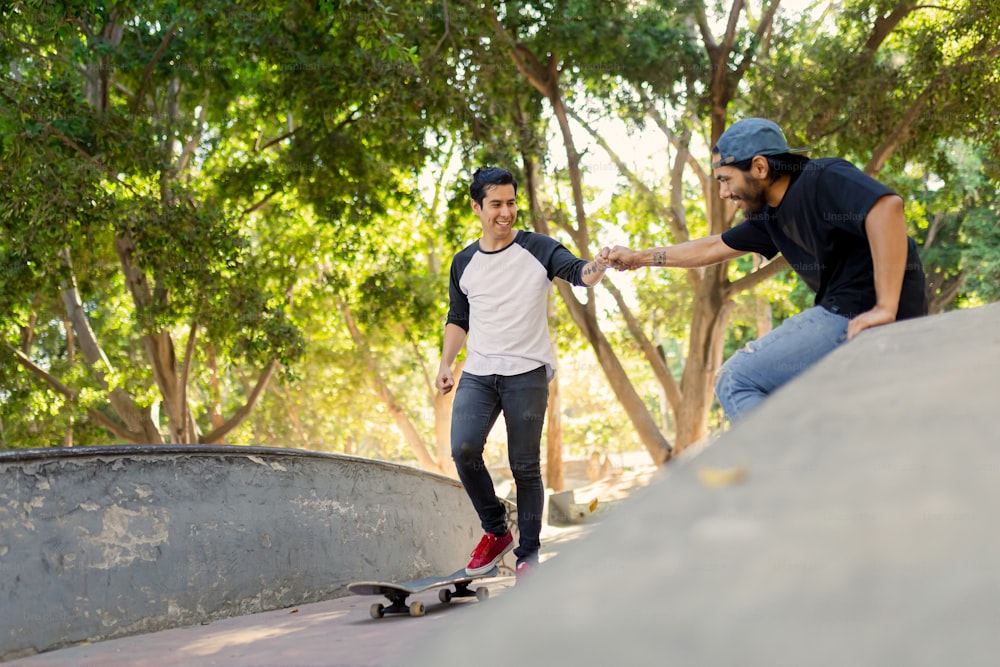 a man riding a skateboard next to another man on a skateboard