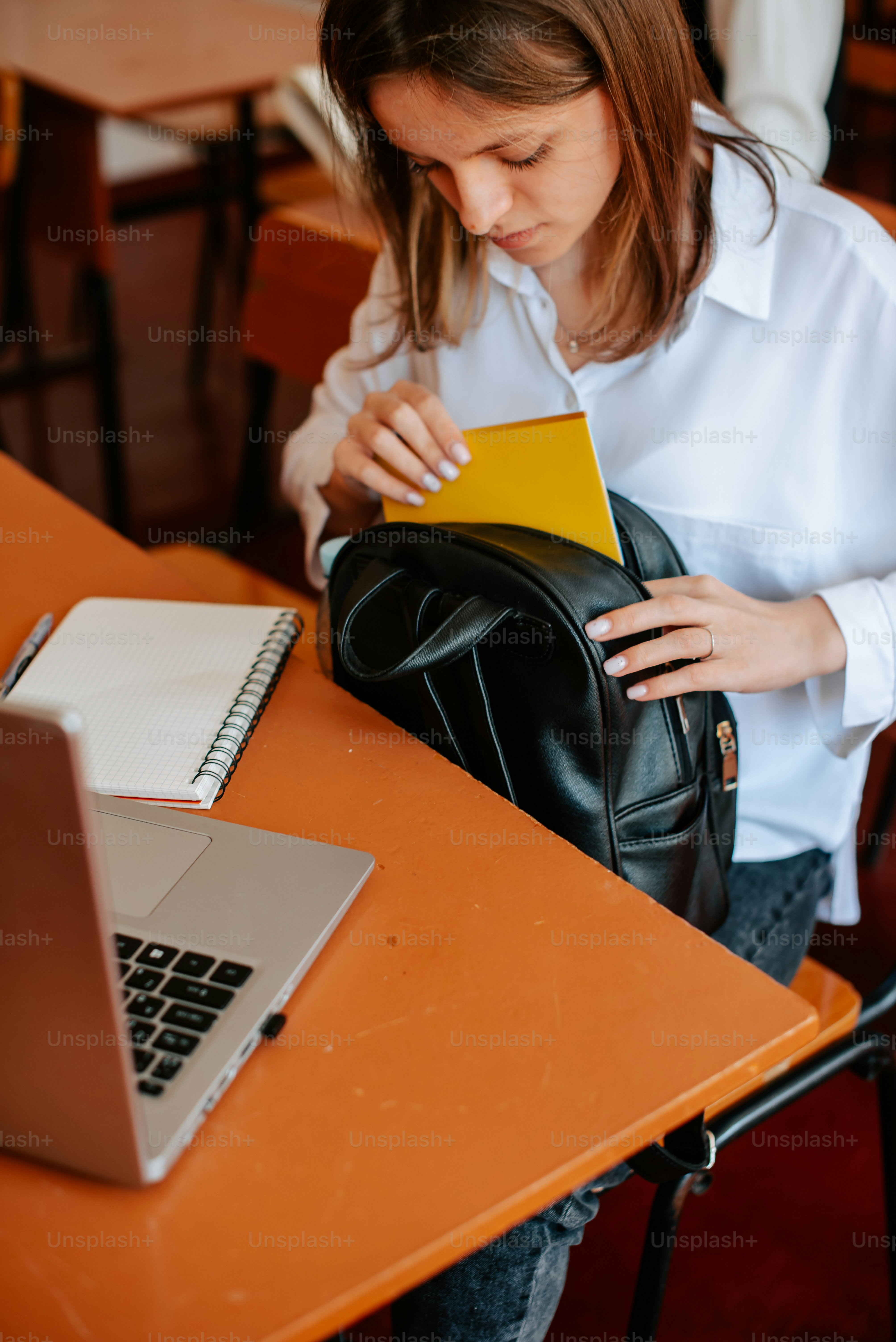 Eine Frau, die mit einem Laptop an einem Tisch sitzt