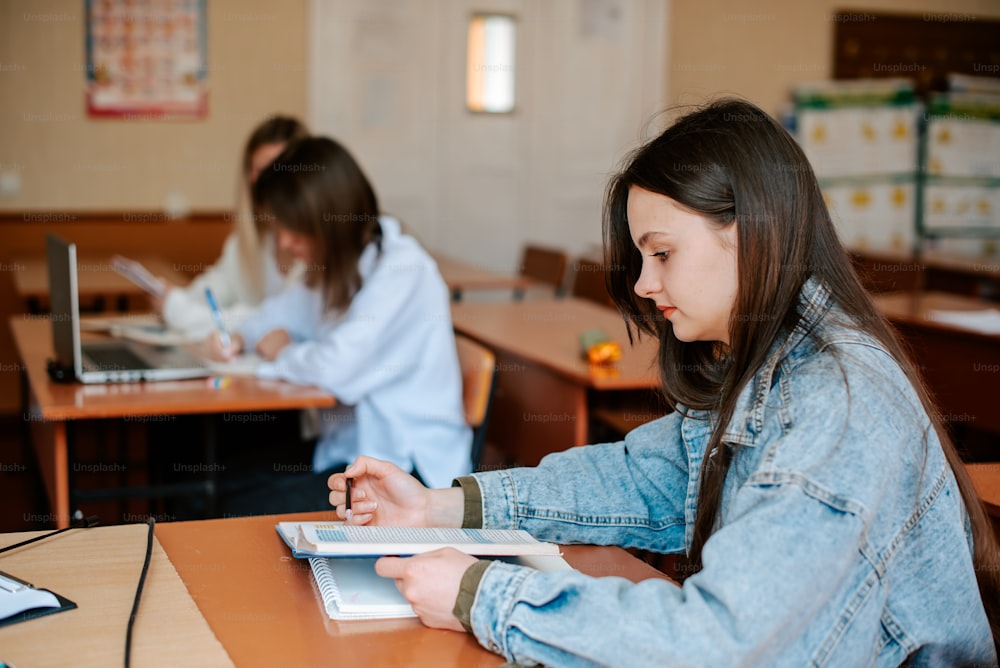 a woman sitting at a table with a book