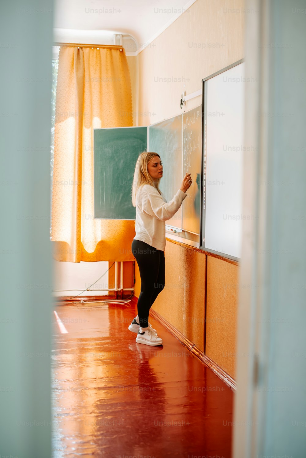 a woman standing in front of a chalk board