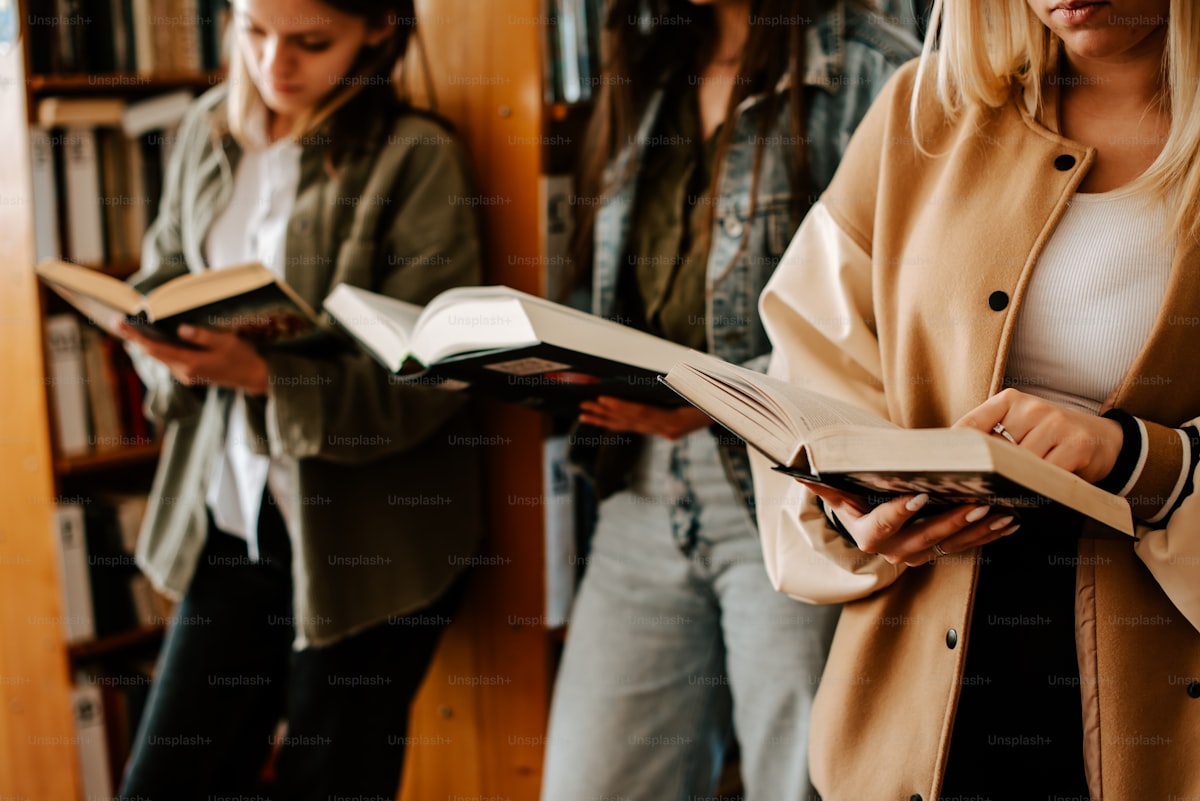 A group of women standing side by side holding open books, book-club register (grayscale)