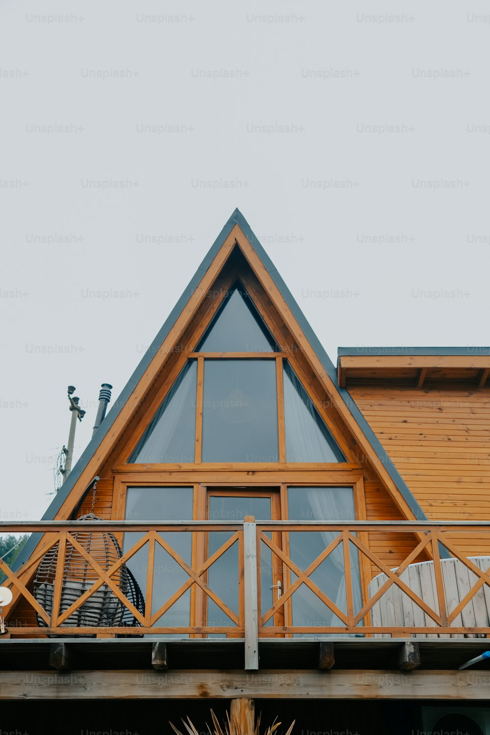 a wooden house with a balcony and a large window