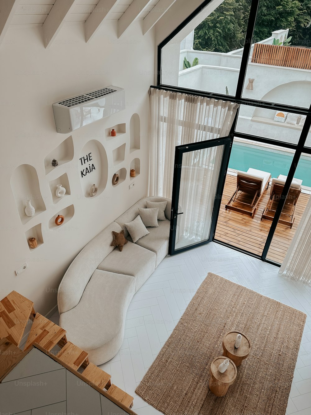 a living room with a white couch and a large window