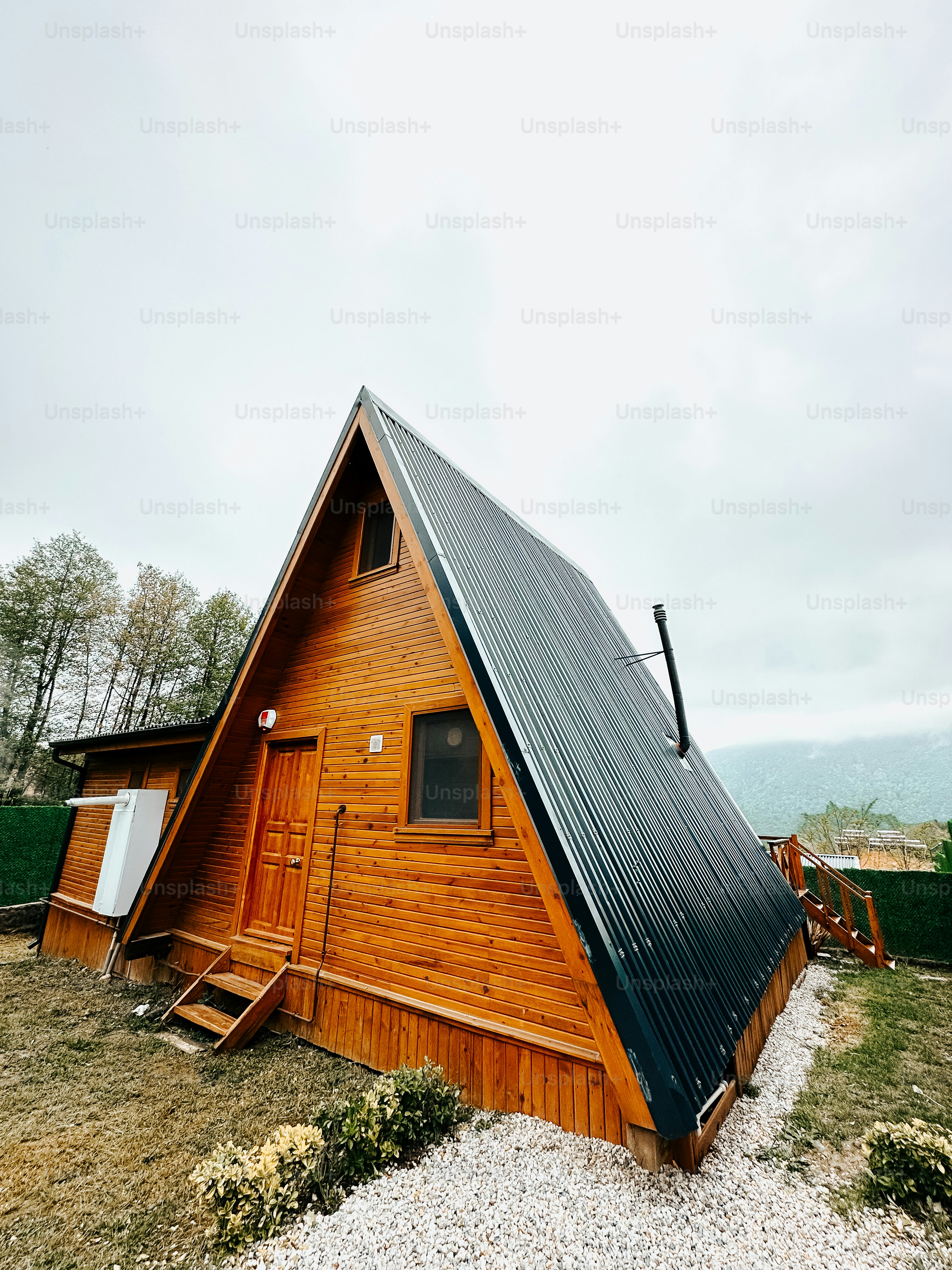 a small wooden cabin with a metal roof